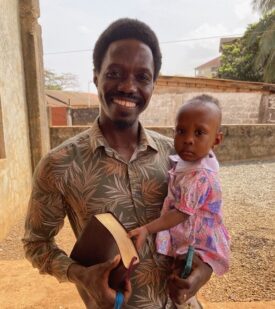 A student and his daughter, whose naming ceremony Nate and Tom attended last March
