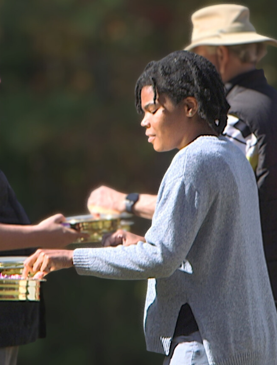 person in white long-sleeved shirt holding book